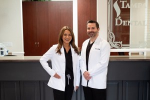 Both doctors posing at front desk
